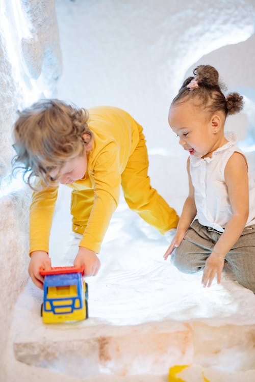 Toddlers Playing with a Toy Car 