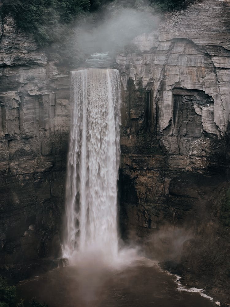 Photo Of Waterfall Falling From Rocky Cliff