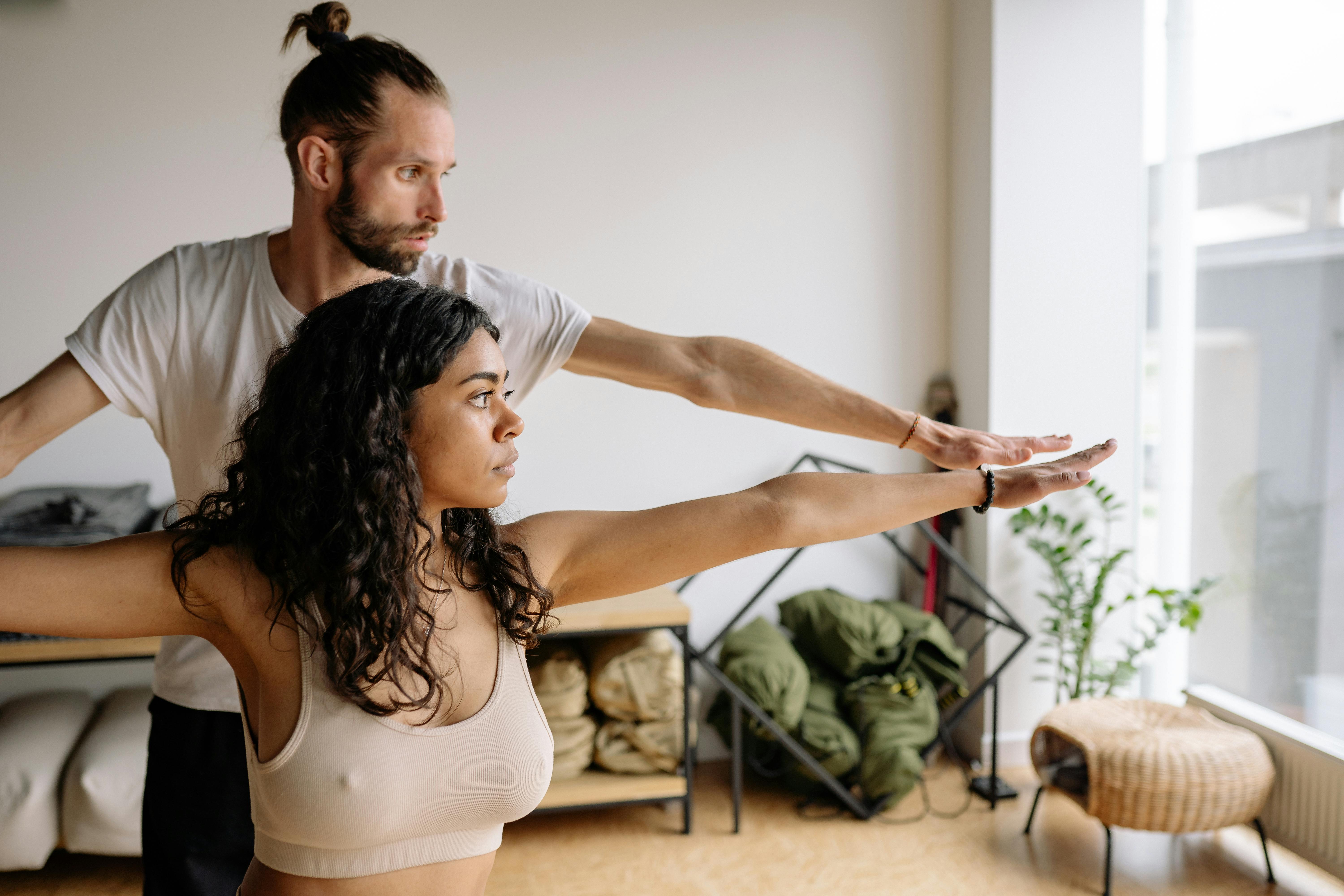 Image of someone modifying a pose with instructor guidance - aerobic yoga classes