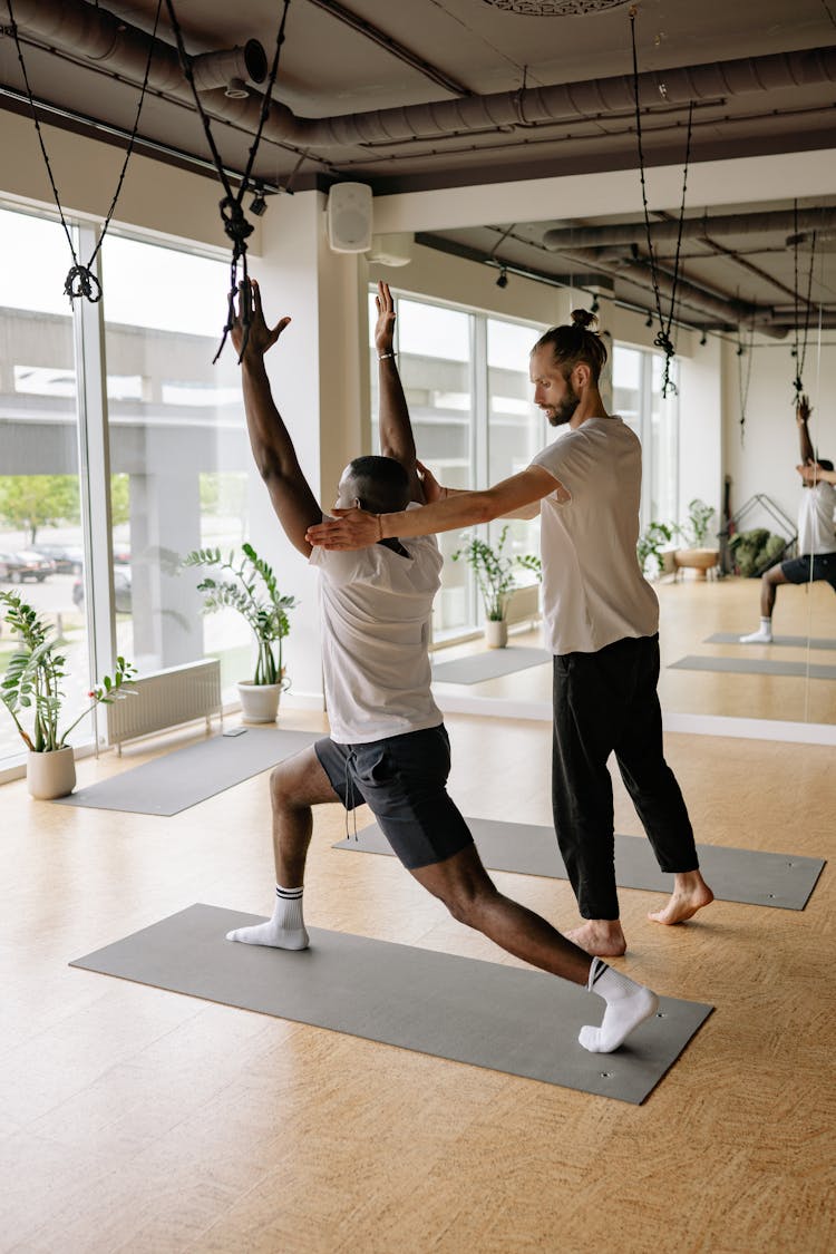 A Man Doing Yoga With An Instructor