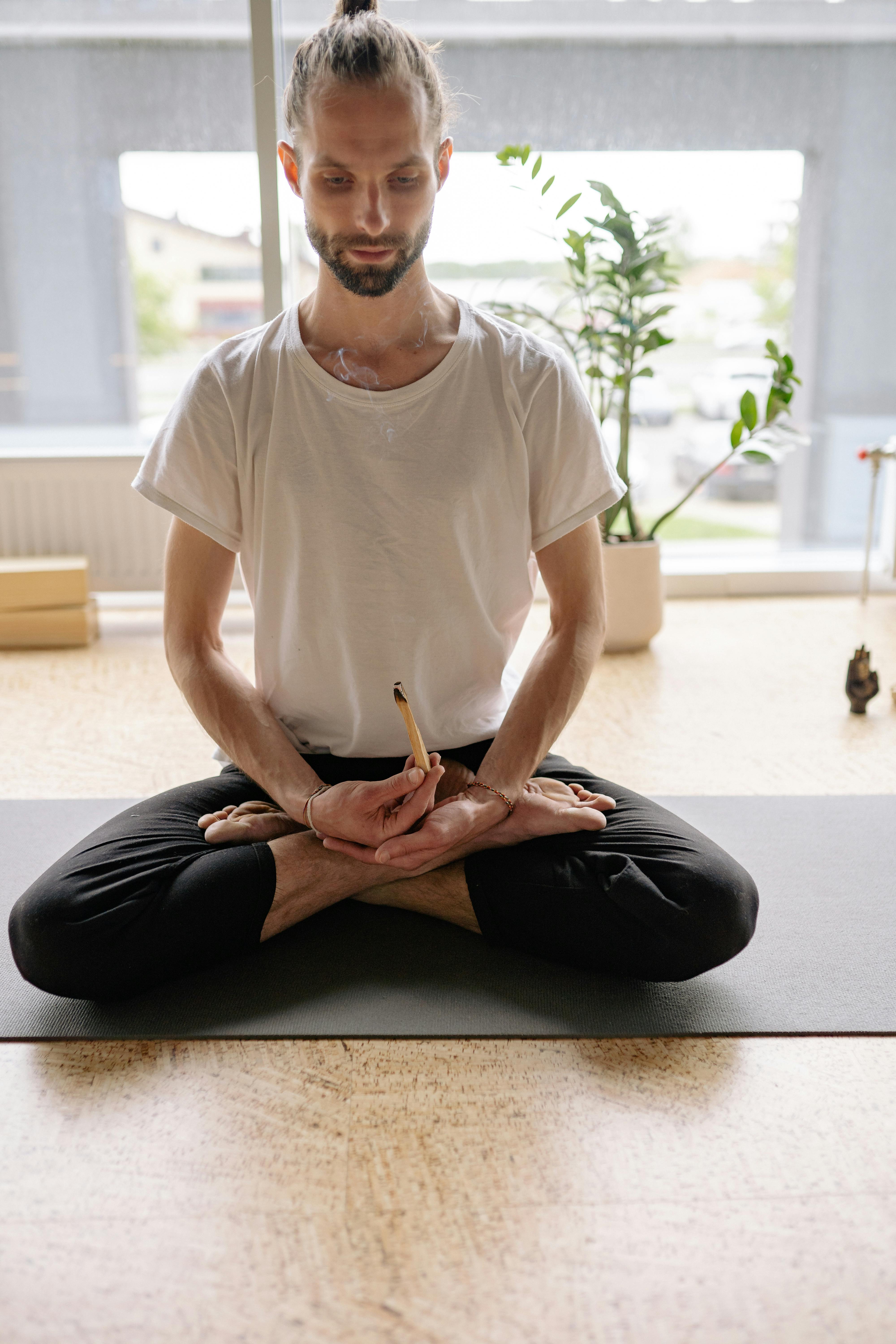 Young woman in Lotus pose with Palo Santo beside · Free Stock Photo