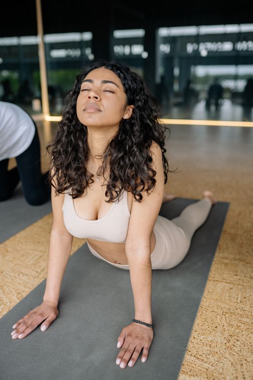 Woman in an upward-facing stretch on a mat — Yan Krukau on Pexels