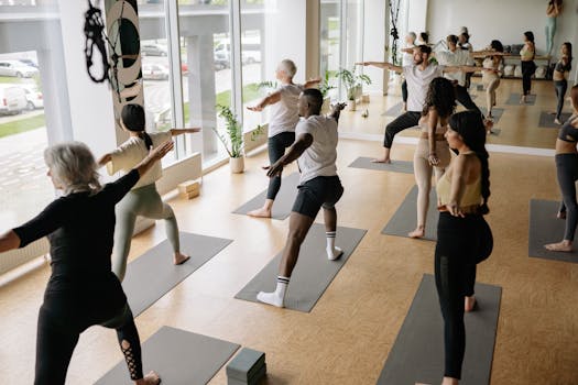 A diverse group of adults practicing yoga indoors, promoting wellness and mindfulness.