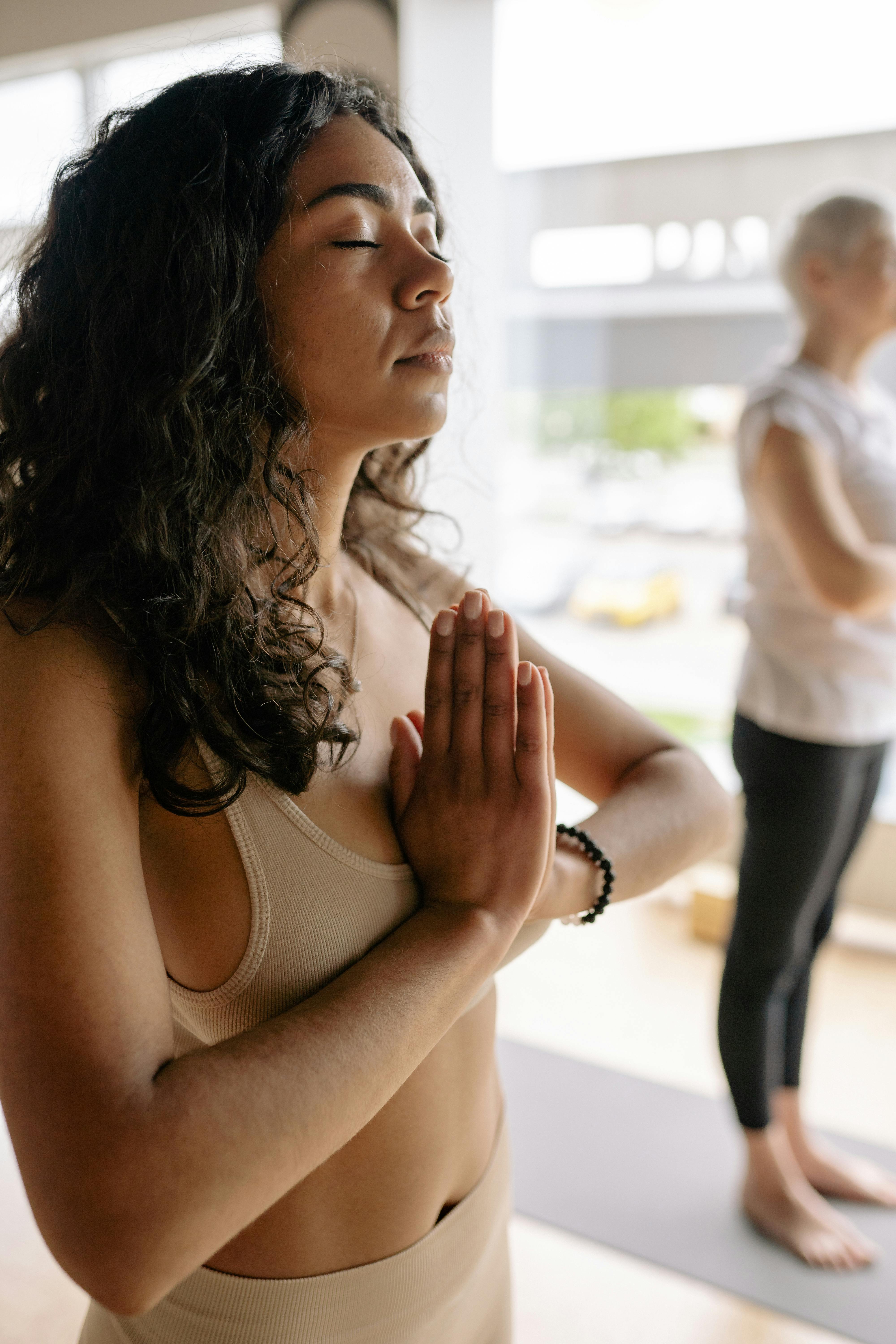 Namaste Everyone. Portrait Shot of Two Young Fit Women Standing and Doing a Yoga  Pose while Looking at the Camera Inside Stock Image - Image of interior,  ethnic: 261298489
