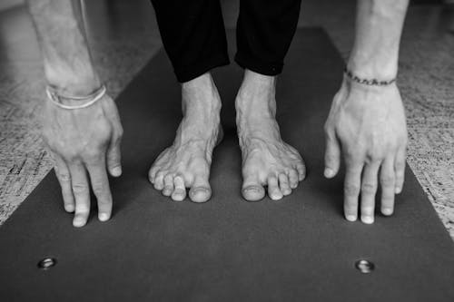 Free 
A Grayscale of a Person's Hands and Feet Stock Photo