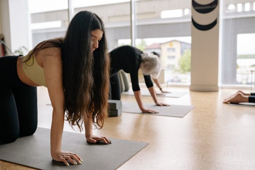 Women of different ages practicing yoga indoors, focusing on relaxation and wellness.