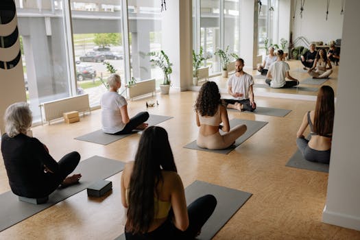 A diverse group practicing yoga indoors on mats, fostering mindfulness and health.