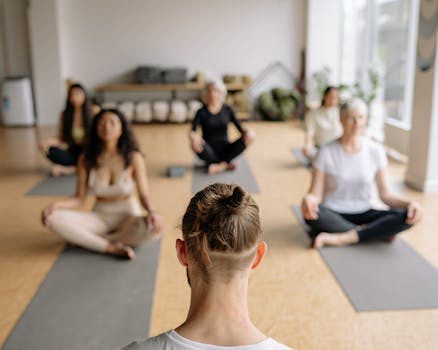 A group of diverse adults practicing yoga indoors, promoting mindfulness and relaxation.