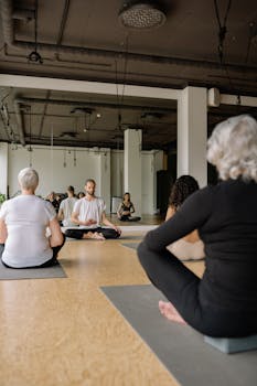A diverse group of individuals practicing yoga together in a serene studio environment.