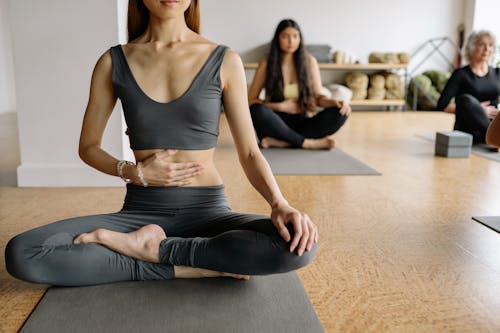 A Woman Doing Yoga on a Gray Yoga Mat