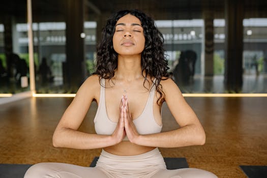 Peaceful woman meditating in a yoga studio, embracing calmness and relaxation.