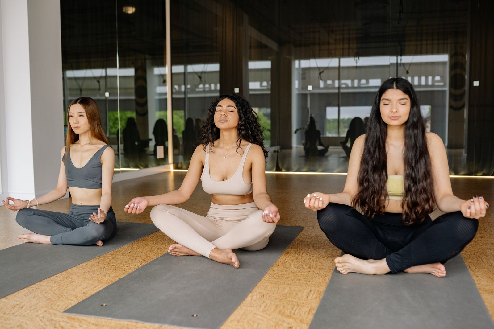 Group of women practicing yoga together indoors for mental wellness