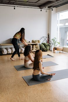 Women practicing yoga at a studio, focused on meditation and wellness.