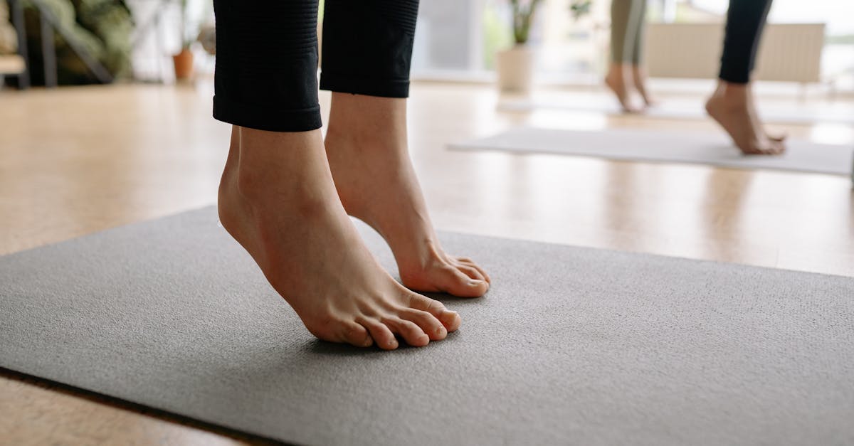 Close-up of bare feet during a yoga session indoors, focusing on mindfulness.