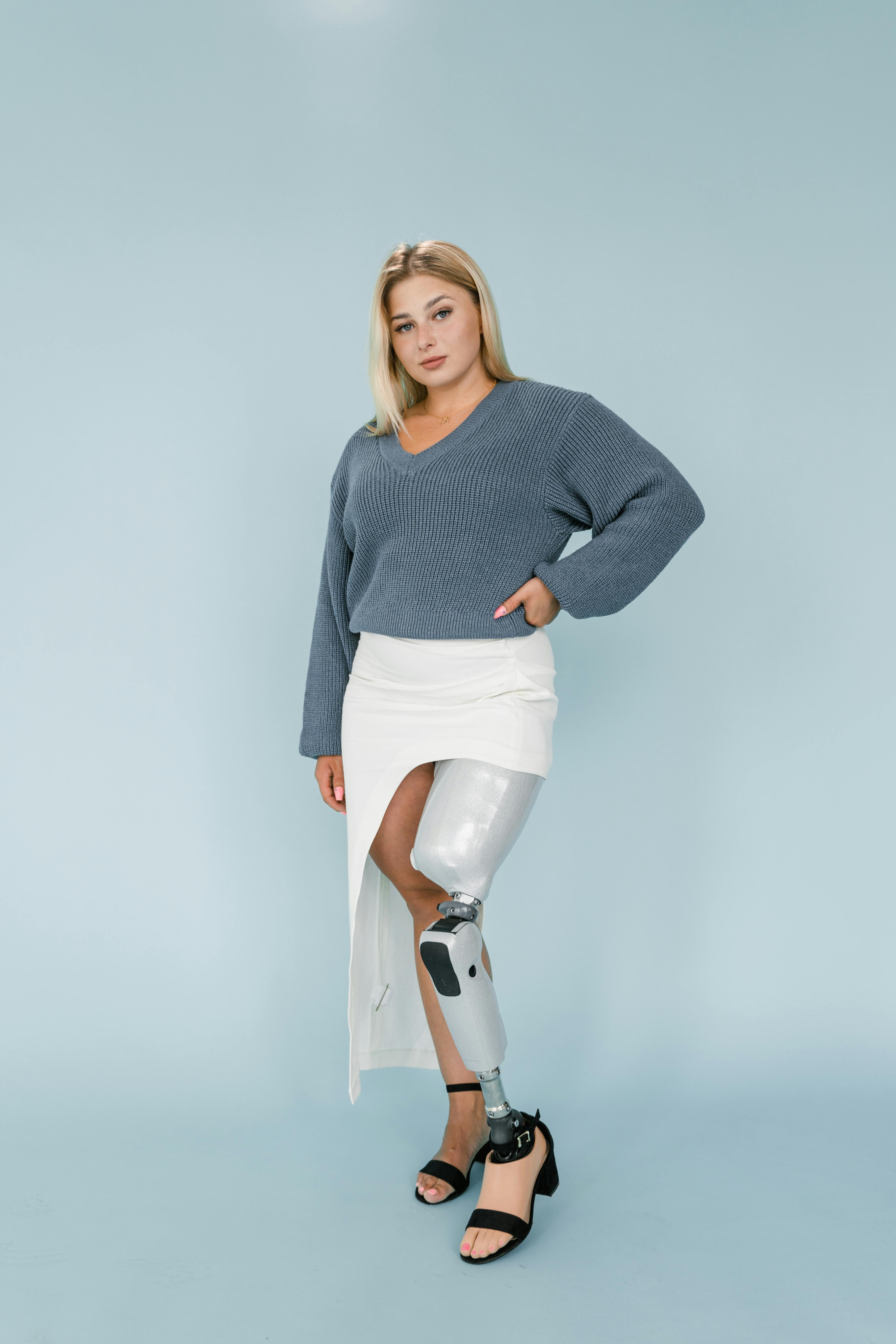 A Woman in Blue Sweater and White Skirt with Prosthetic Leg · Free Stock  Photo