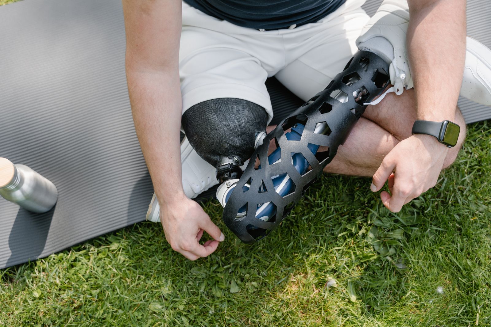 Runner stretching a knee outdoors before activity