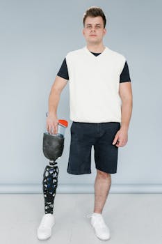 Portrait of a confident man with a prosthetic leg showcasing modern fashion in a studio setting.