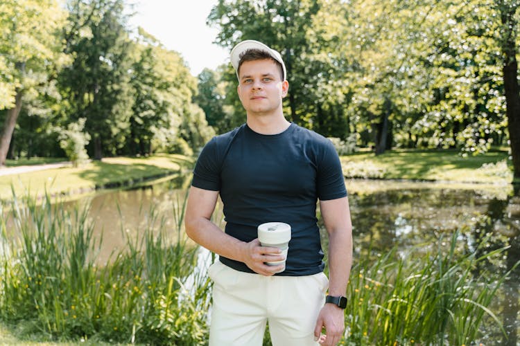 Man In Black Shirt Holding A Cup