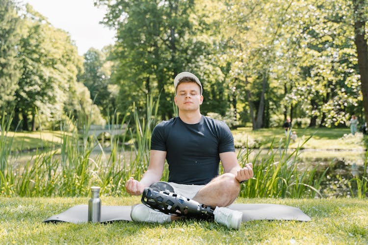 A Man In Black Shirt Meditating 