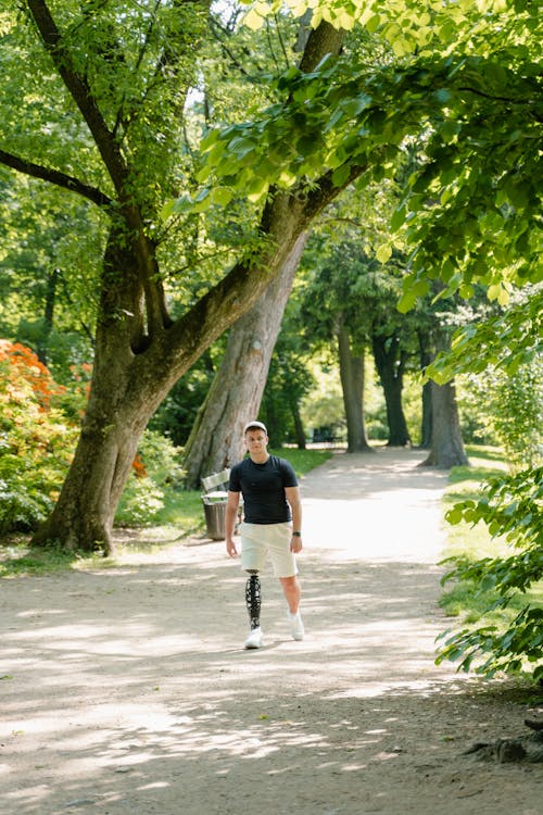Free Man in Black Shirt Walking at the Park Stock Photo