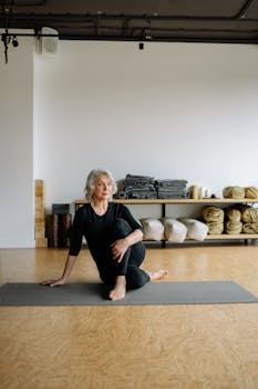 Elderly woman performing yoga pose on mat, promoting wellness and healthy living.