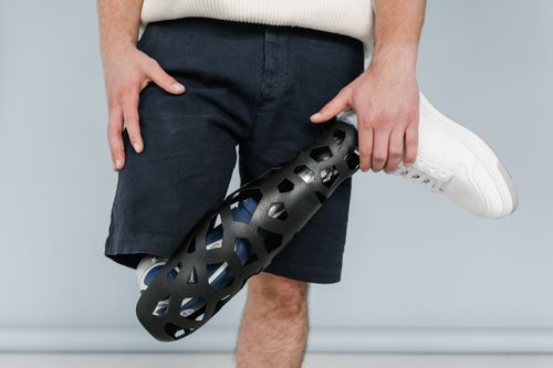 Free Close-up of a person with a sleek modern prosthetic leg, emphasizing cutting-edge design. Stock Photo