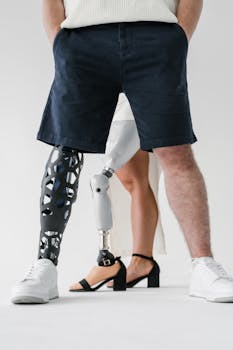 Close-up of two adults with advanced prosthetic legs, showcasing modern technology and style.