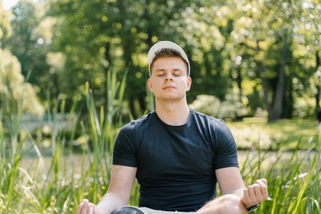 A Man in Black Shirt Meditating · Free Stock Photo