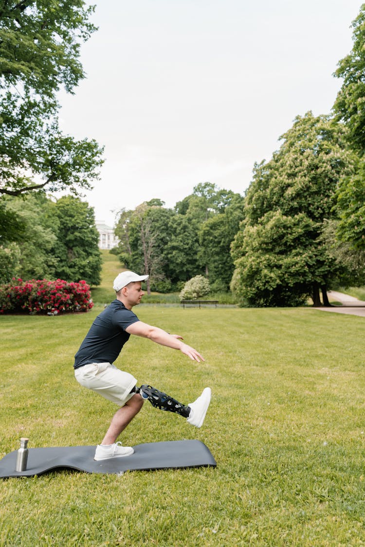 A Man In Black Shirt Exercising At The Park