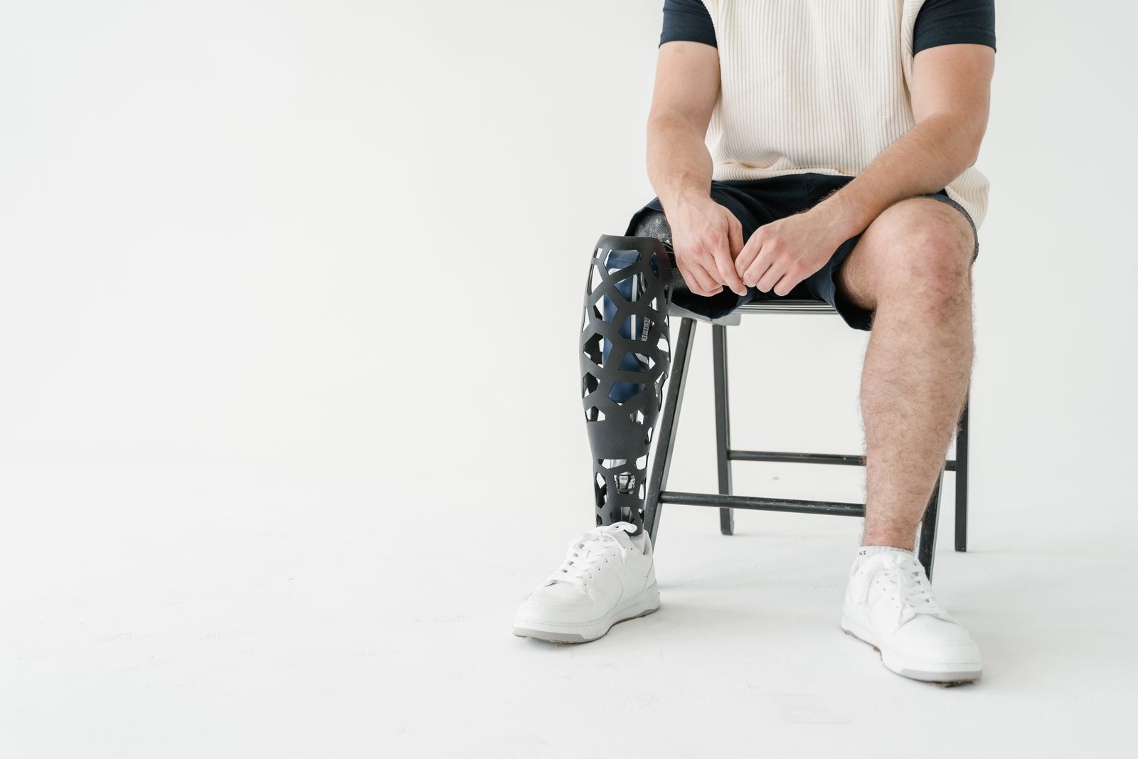Person measuring around the knee with a tape measure for brace sizing