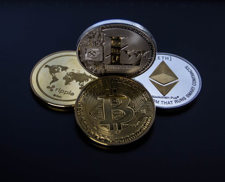 Four Assorted Cryptocurrency Coins · Free Stock Photo