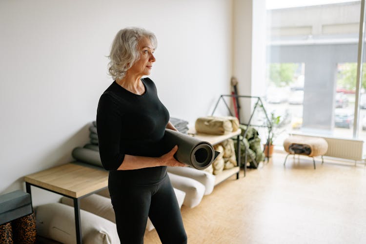 Elderly Woman Holding A Yoga Mat