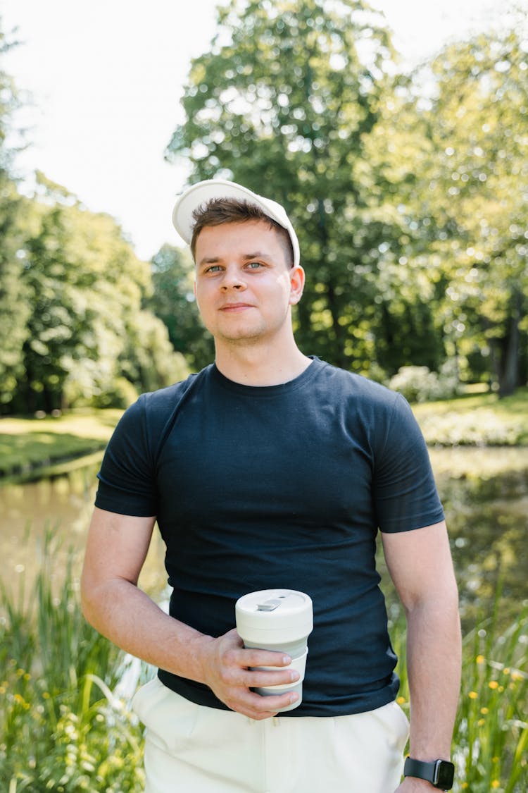 Portrait Of A Man In Black Shirt Holding A Tumbler