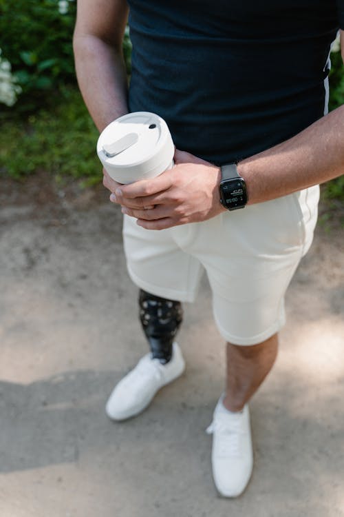 Close Up Photo of a Man Holding a Cup