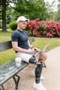 Man in Black Shirt Sitting on Brown Wooden Bench using Laptop