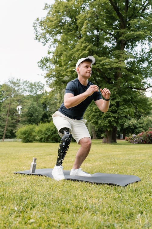 Photo of Person in Black Shirt Exercising at the Park