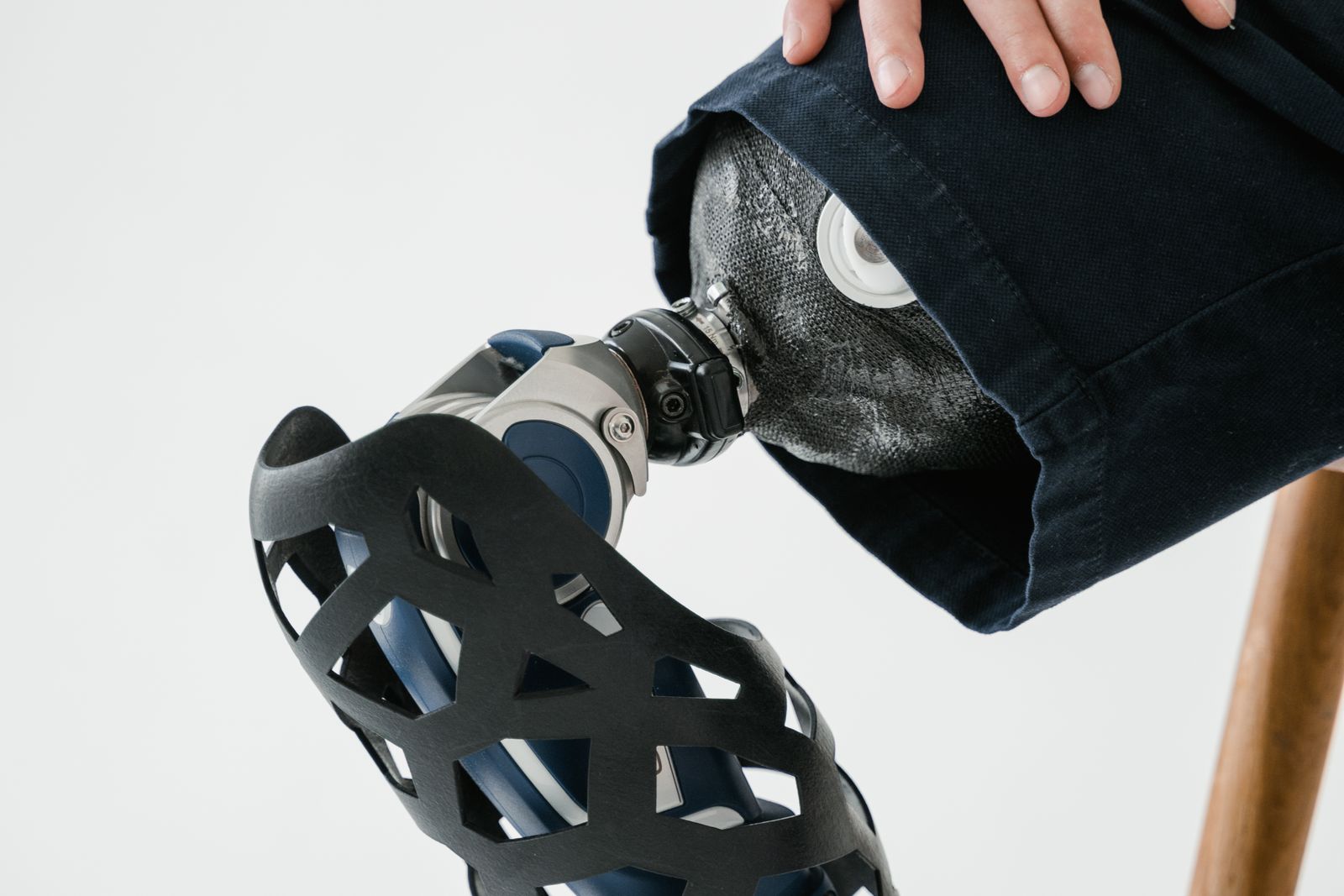 Person outdoors adjusting a knee support before walking on a bright path