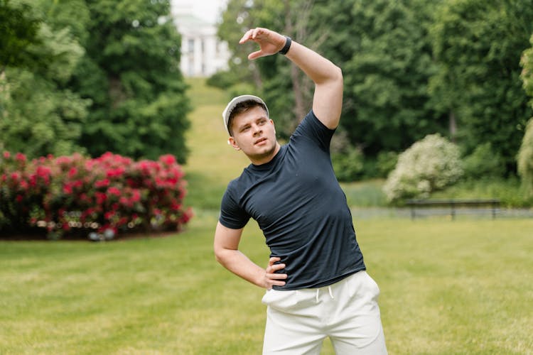 A Man In Black Shirt Exercising