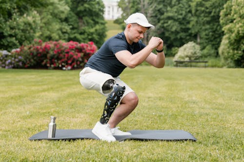 A Man in Black Shirt Exercising at the Park