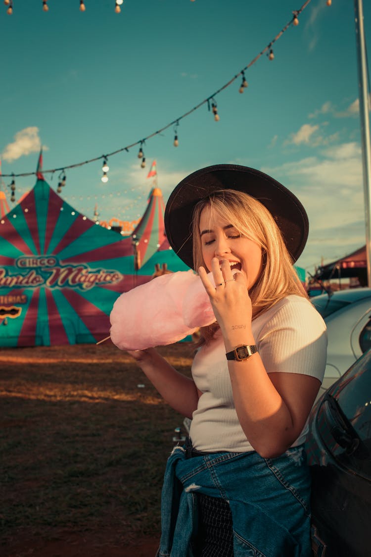 Blonde Woman With Hat Eating Candyfloss