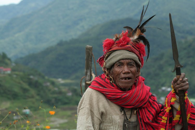 An Elderly Man Holding A Spear