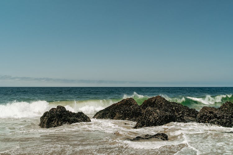 Photo Of Ocean Waves Crashing On Rocks