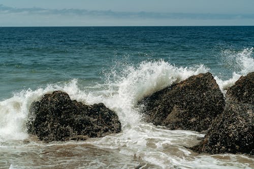 Photo of Sea Waves Crashing  on Two Rocks