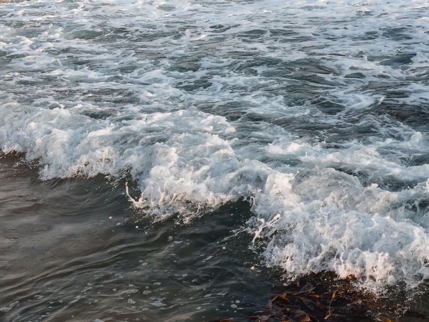 Dynamic ocean waves crashing on rocks, capturing the beauty of nature's power.
