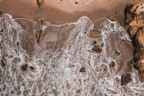 Top View of Sea Waves Crashing on Beach Shore