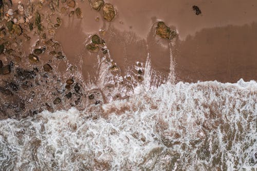 Top View of Sea Waves Crashing on Rocky Shore