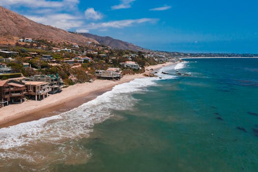 A breathtaking aerial view of Malibu's beachfront homes along the scenic coastline.