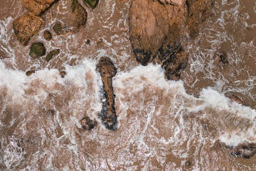 Water Waves Hitting Brown Rock