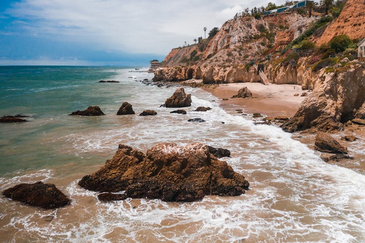 Rocky Cliff Near Body Of Water