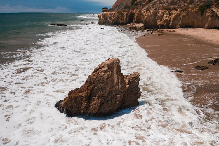 A Brown Rock On Sea Shore